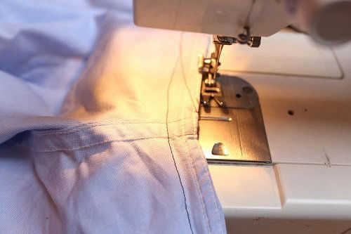Sewing shirt on a sewing machine at home